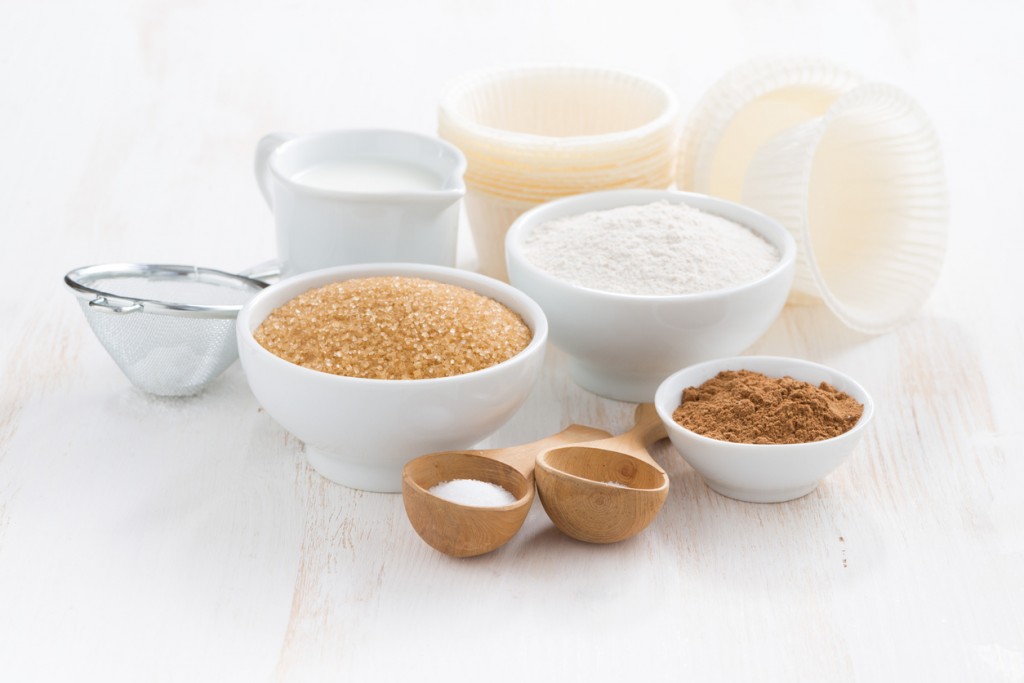 Ingredients for baking muffins on a white wooden background, horizontal