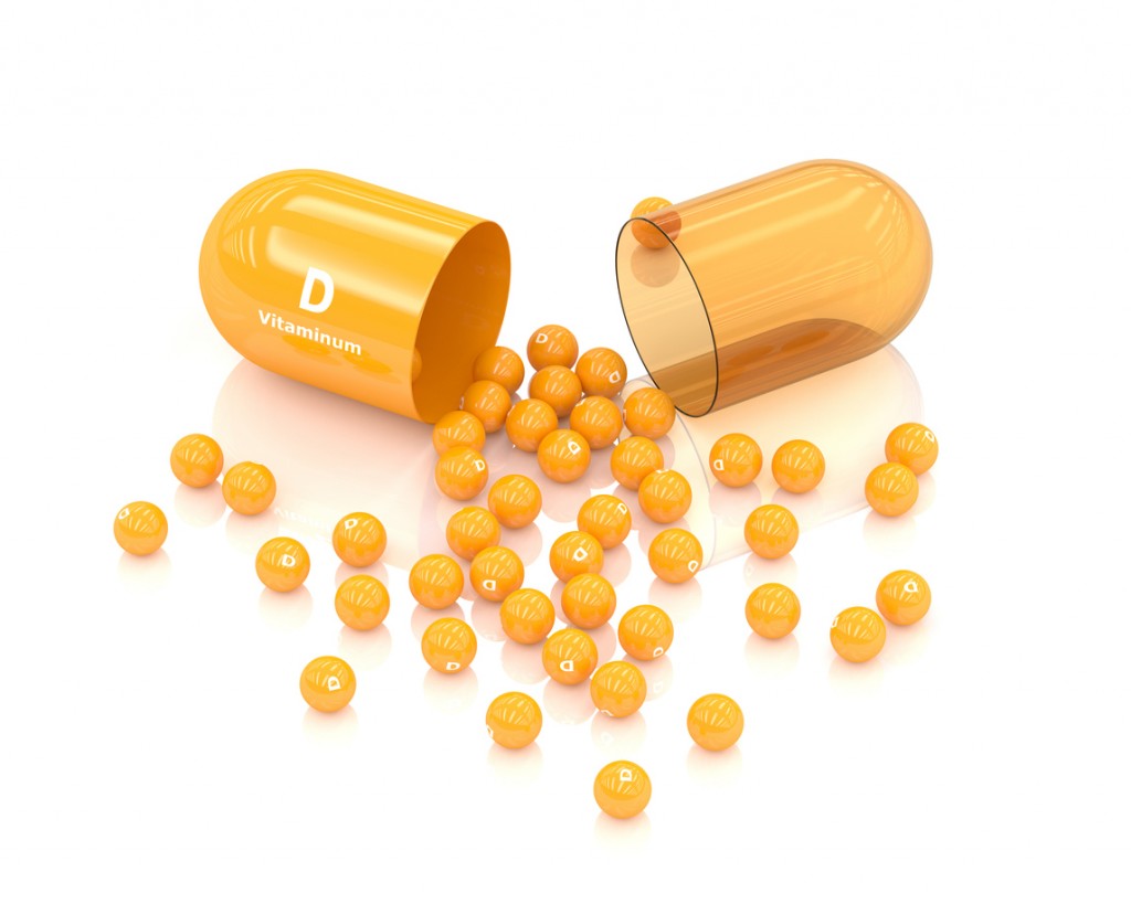 3d rendering vitamin D capsule lying on white background. Concept of dietary supplements