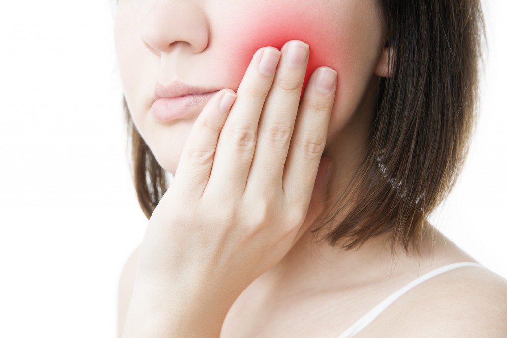 Toothache. Woman's face isolated white background