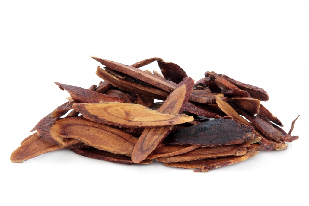 Liquorice root honey baked used in chinese herbal medicine over white background. Zhi gan cao.