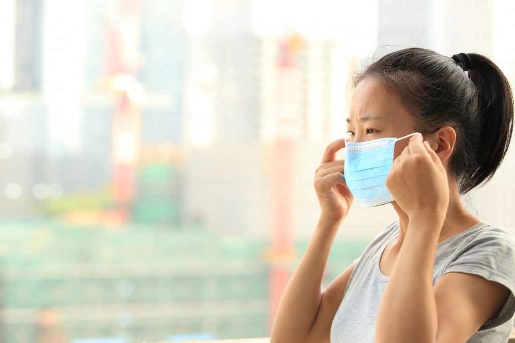asian woman wear protective face mask on city