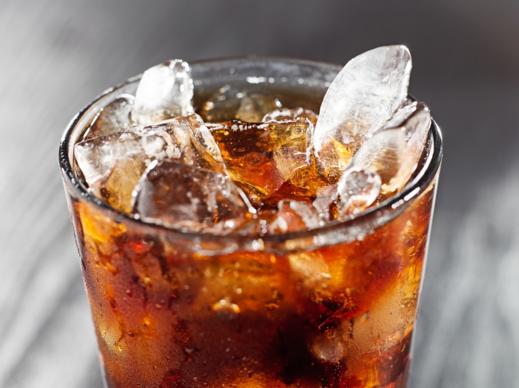 glass of cola with ice, shot close up with selective focus.
