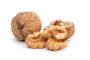 Whole and broken walnuts on white.