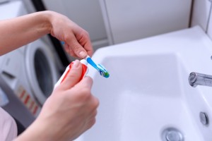 toothbrush and toothpaste close up in  bathroom