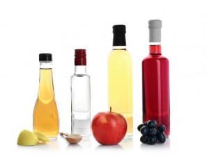 Composition with different kinds of vinegar and ingredients on white background