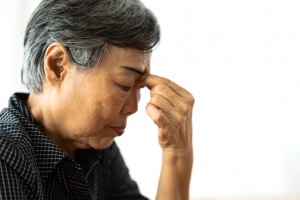 Senior adult elderly asia women serious depressed and feeling headache, thinking of problems on white background