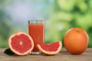 Grapefruit juice and fresh grapefruits in summer
