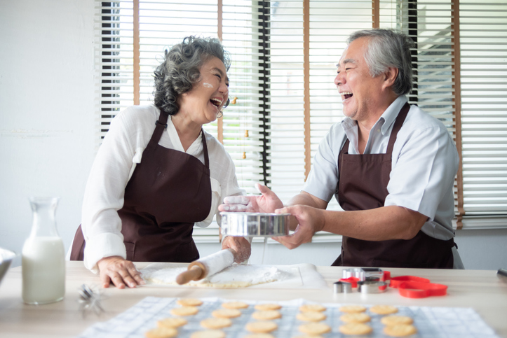 senior couple baking cookies.